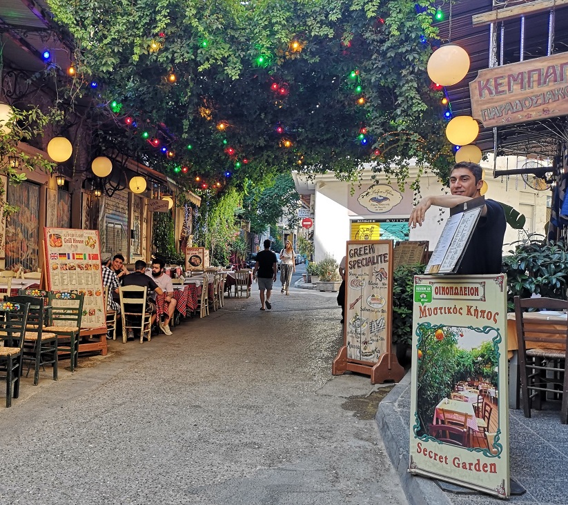 Coloured fairy lights and vines hang above Eschilou street