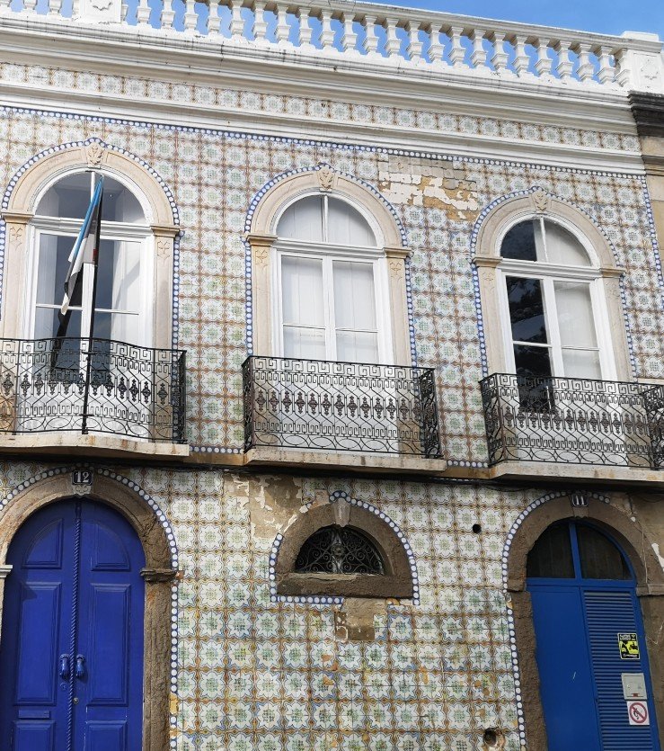 Building in Tavira showing the blue and white decoration, balustrades and tiled exterior, Portugal